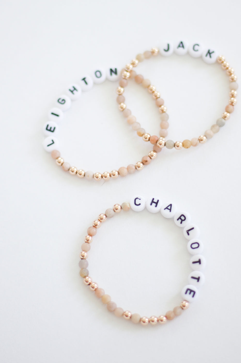 Pink 18K Gold beaded bracelet stack with custom letter beads